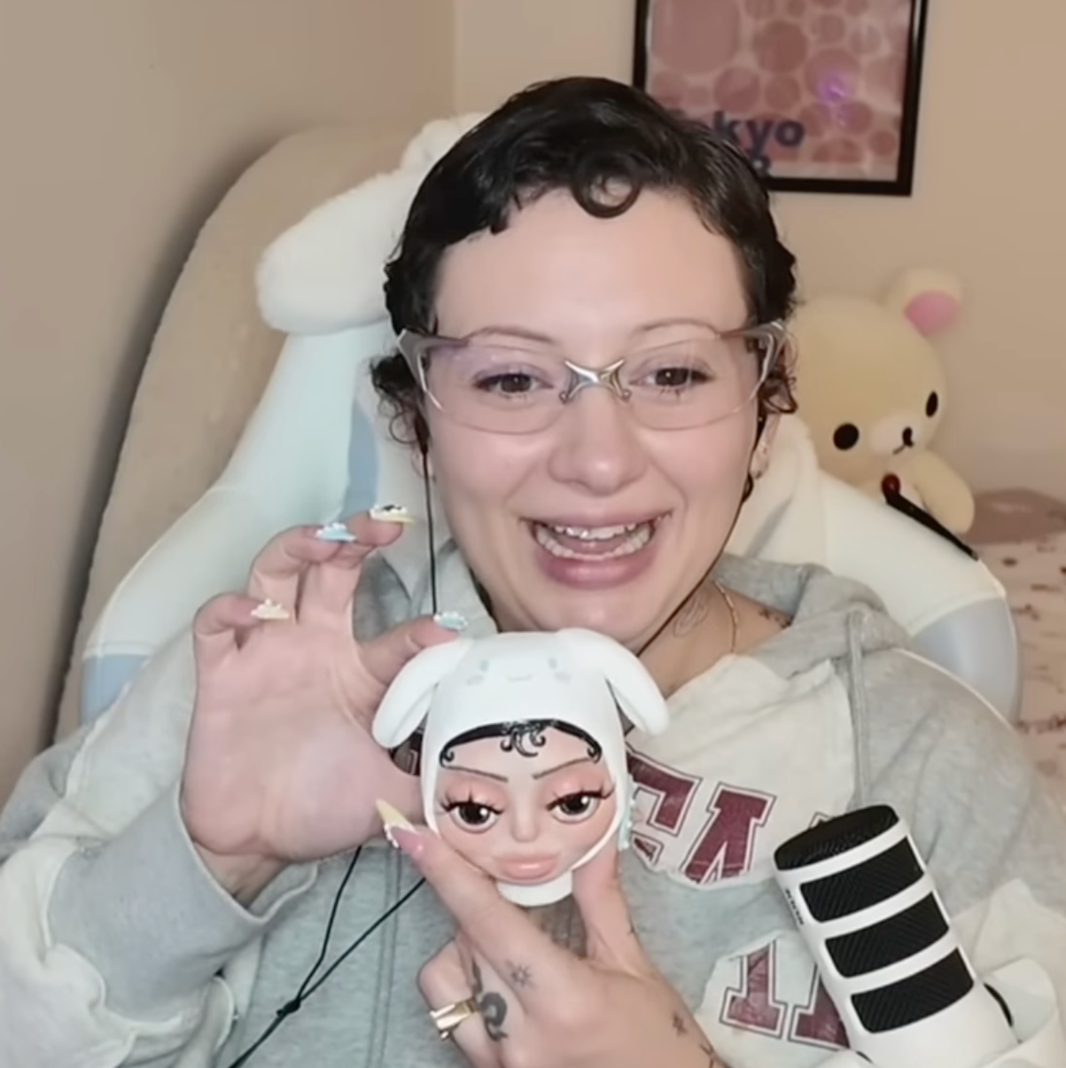 A polymer clay art sculpture of Vanilla Mace's head in a cinamoroll beanie and her two cats, Miso and Chai.