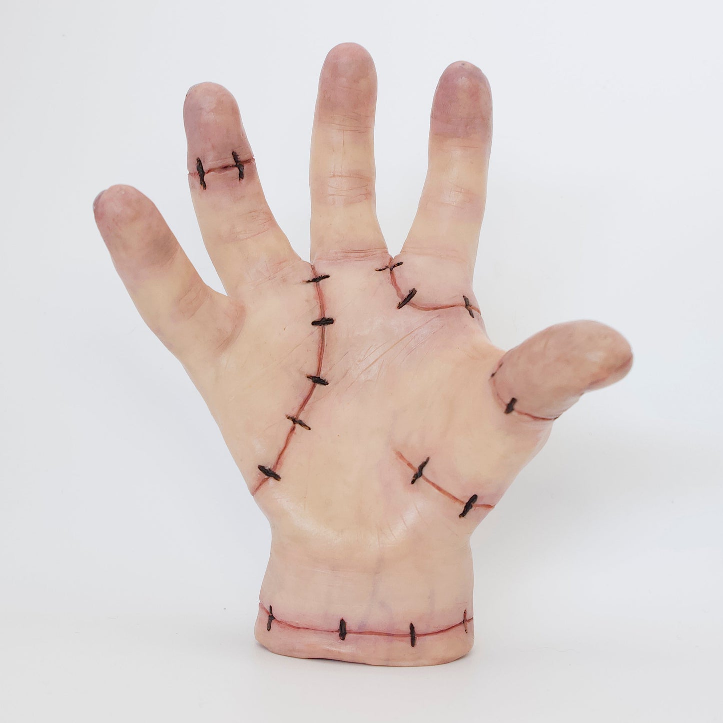 Polymer clay sculpture of thing, the hand from Addams family. Featuring stitched skin and glossy nails with a hole in the wrist to store small items. 