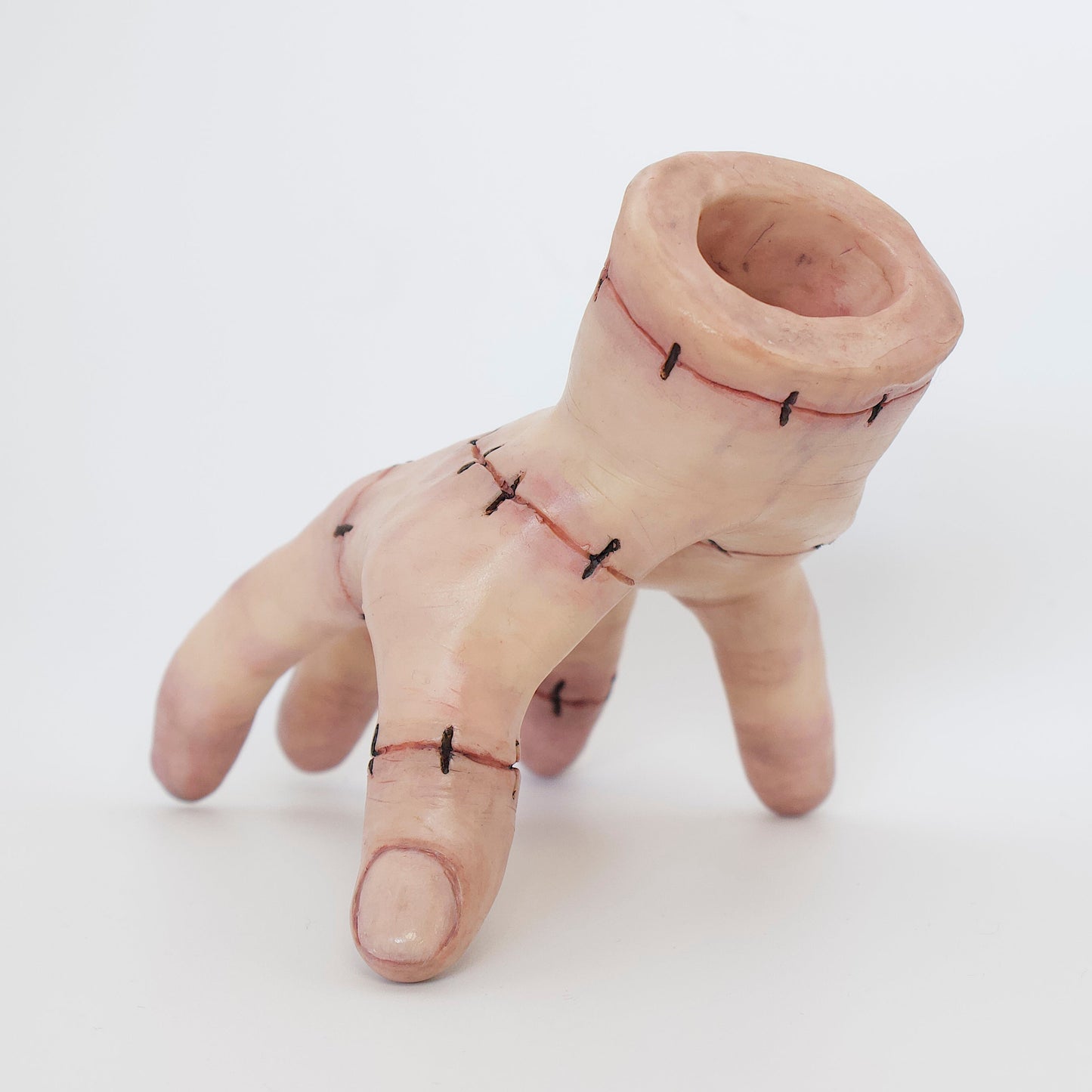 Polymer clay sculpture of thing, the hand from Addams family. Featuring stitched skin and glossy nails with a hole in the wrist to store small items. 